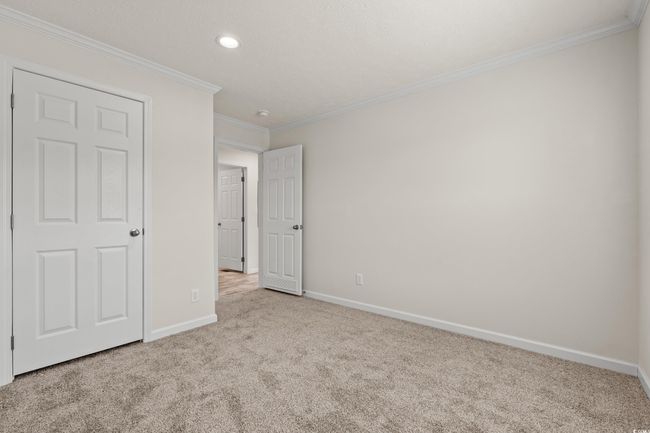 Unfurnished bedroom featuring recessed lighting, baseboards, ornamental molding, and carpet floors | Image 23