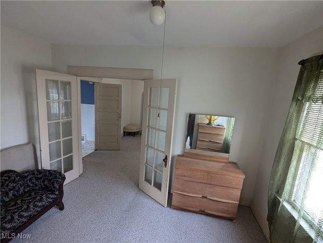 First-Floor Carpeted bedroom featuring ceiling fan and french doors | Image 12