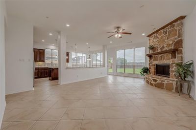 Floor to ceiling windows flood the room with natural light, creating a bright and inviting atmosphere while offering a stunning view of the backyard. | Image 3