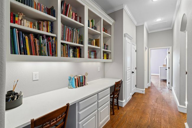 Hall featuring crown molding, baseboards, and wood finished floors | Image 25
