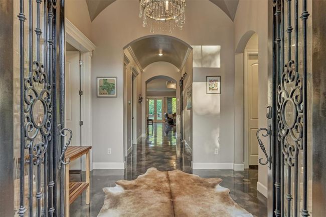 Step into the beautiful entry foyer, featuring a stunning crystal chandelier and a custom groin-vaulted ceiling finished in a soft pearl shimmer. | Image 7