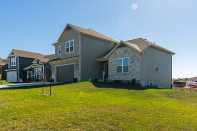 Featuring a rode iron fence and a sprinkler system. | Image 3