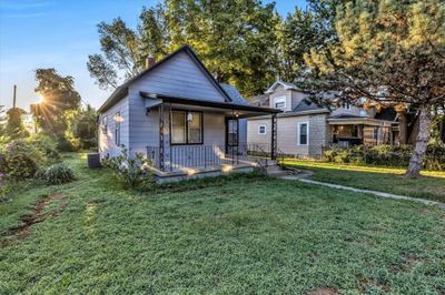 Bungalow featuring a front lawn and a porch | Image 2