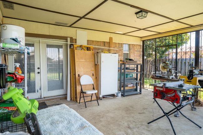 Large covered back patio surrounded by rod iron. | Image 7
