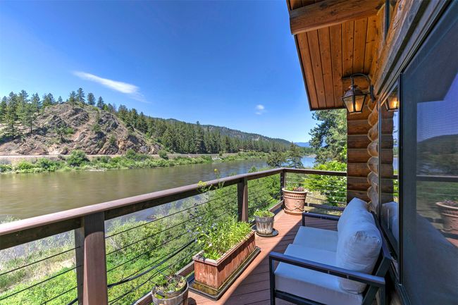 Balcony with a water and mountain view and a view of trees | Image 38