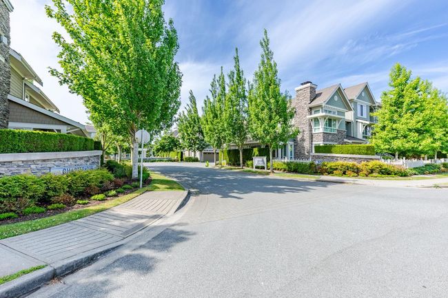 View of asphalt road with sidewalks, curbs, and traffic signs | Image 38