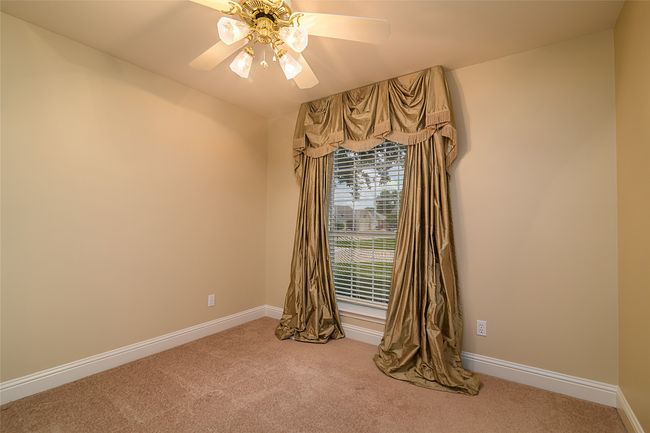 Spare room featuring a ceiling fan, carpet, and baseboards | Image 17