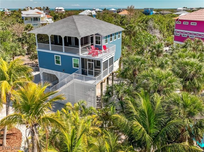 Back of house with stairs, roof with shingles, an attached garage, and a balcony | Image 6