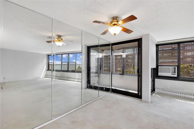 Unfurnished room with a textured ceiling, a ceiling fan, and cooling unit | Image 7