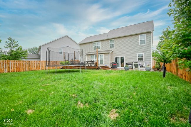 back of property with a trampoline and a wooden deck | Image 10