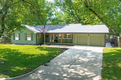 Ranch-style home with a front lawn and a garage | Image 2