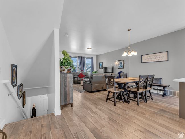 Dining area featuring light wood-style floors and a chandelier | Image 8