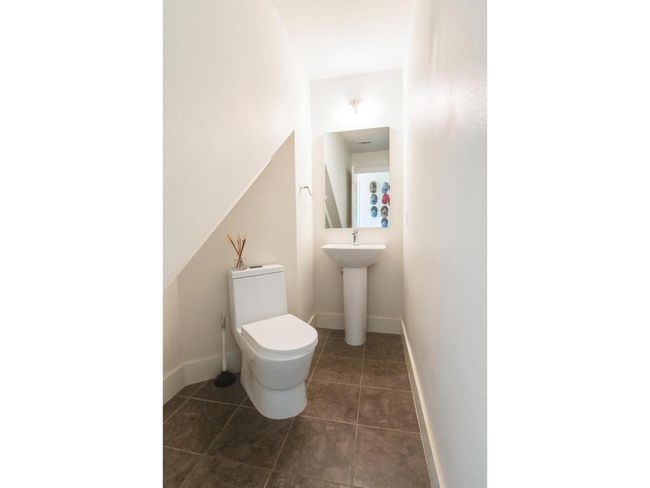 Bathroom with toilet and tile patterned floors | Image 19