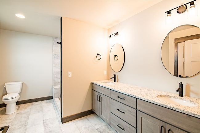 Bathroom with vanity, toilet, and a shower | Image 15