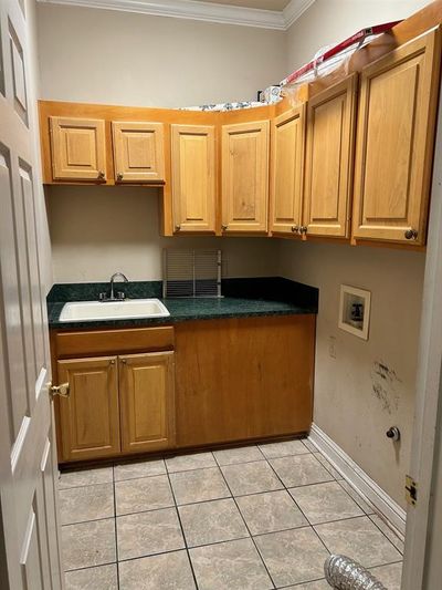 Kitchen with ornamental molding, sink, and light tile patterned floors | Image 3