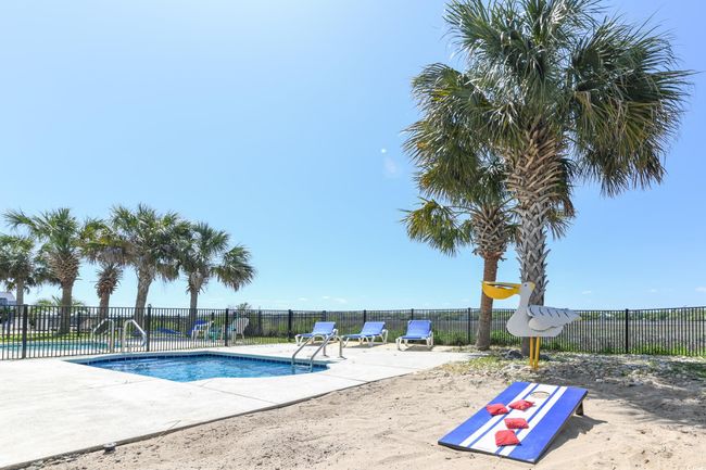 Community pool with a patio area and fence | Image 30