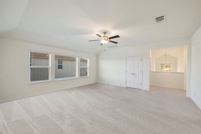 Spare room featuring ceiling fan, light carpet, and baseboards | Image 27