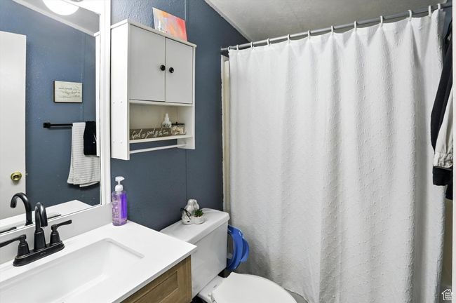 Bathroom with vanity and curtained shower | Image 18