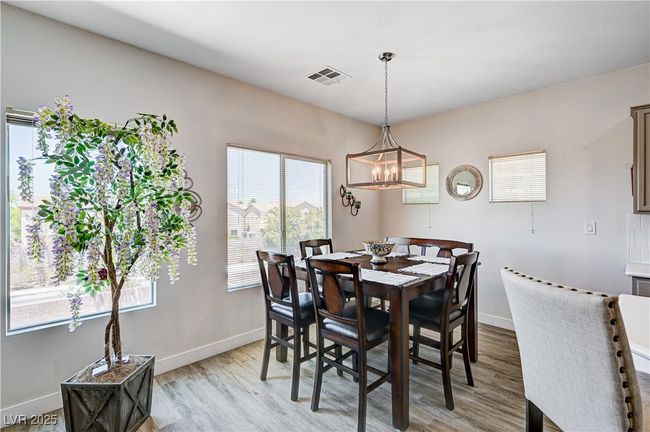 Dining space featuring a chandelier and light wood-style flooring | Image 7