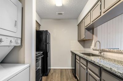 Updated kitchen overlooking living area | Image 3