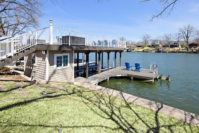 Dock area with stairway, a lawn, and a water view | Image 19