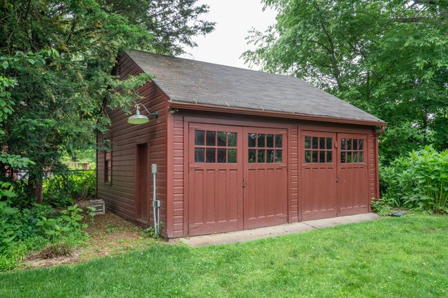 Two large double doors open to an expasive garage space. Plenty of room for 2 cars. | Image 32