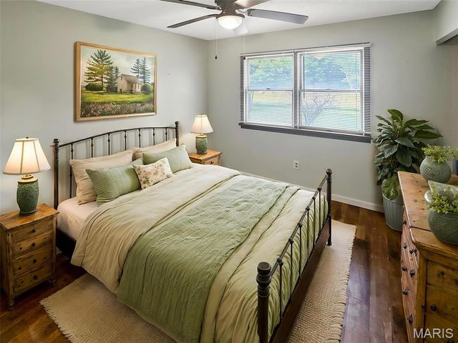 Bedroom with wood finished floors and a ceiling fan | Image 11