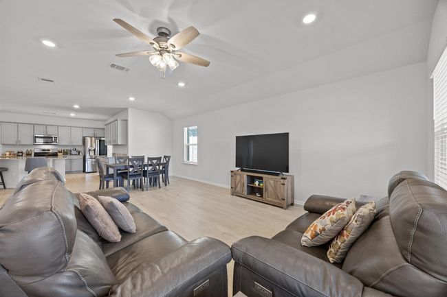 Living room with recessed lighting, ceiling fan, and light wood-look floors | Image 16