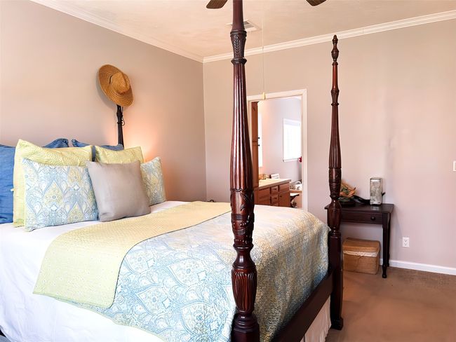 Bedroom featuring baseboards, carpet flooring, a ceiling fan, and crown molding | Image 27