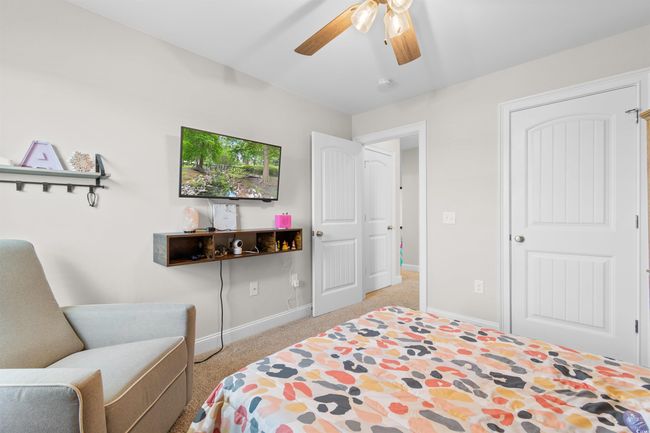 Bedroom with light carpet and ceiling fan | Image 22