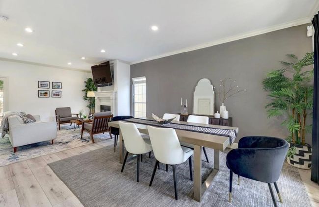 Dining space featuring a fireplace, crown molding, recessed lighting, and light wood-type flooring | Image 16