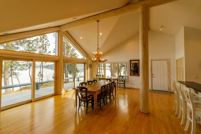 Dining space with light hardwood / wood-style flooring, plenty of natural light, beam ceiling, and high vaulted ceiling | Image 27
