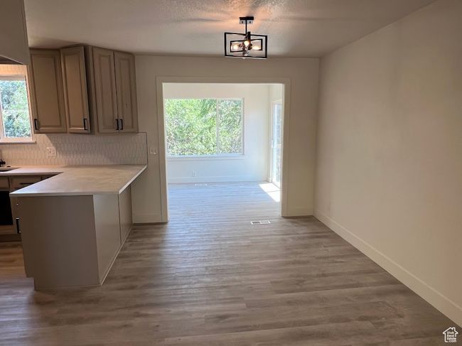 Corridor featuring healthy amount of natural light and light wood finished floors | Image 10