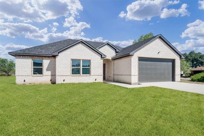 View of front of property featuring a garage and a front yard | Image 2