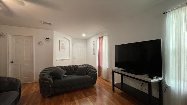 Living room with wood finished floors and recessed lighting | Image 5