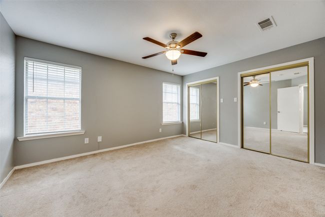 Unfurnished bedroom featuring two closets, carpet, and ceiling fan | Image 8