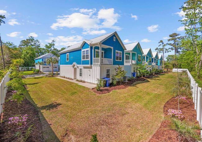 View of home's exterior with a lawn, a fenced backyard, and metal roof | Image 35