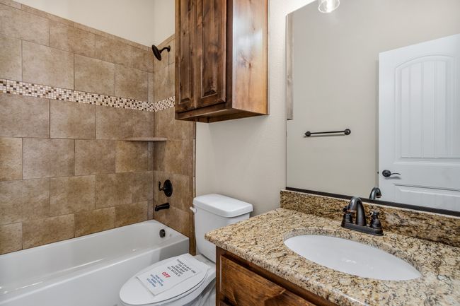 Bathroom with toilet, vanity, and shower combination | Image 22