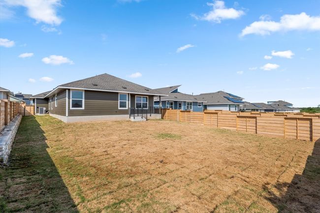 Back of property with a fenced backyard, a shingled roof, and a patio | Image 28