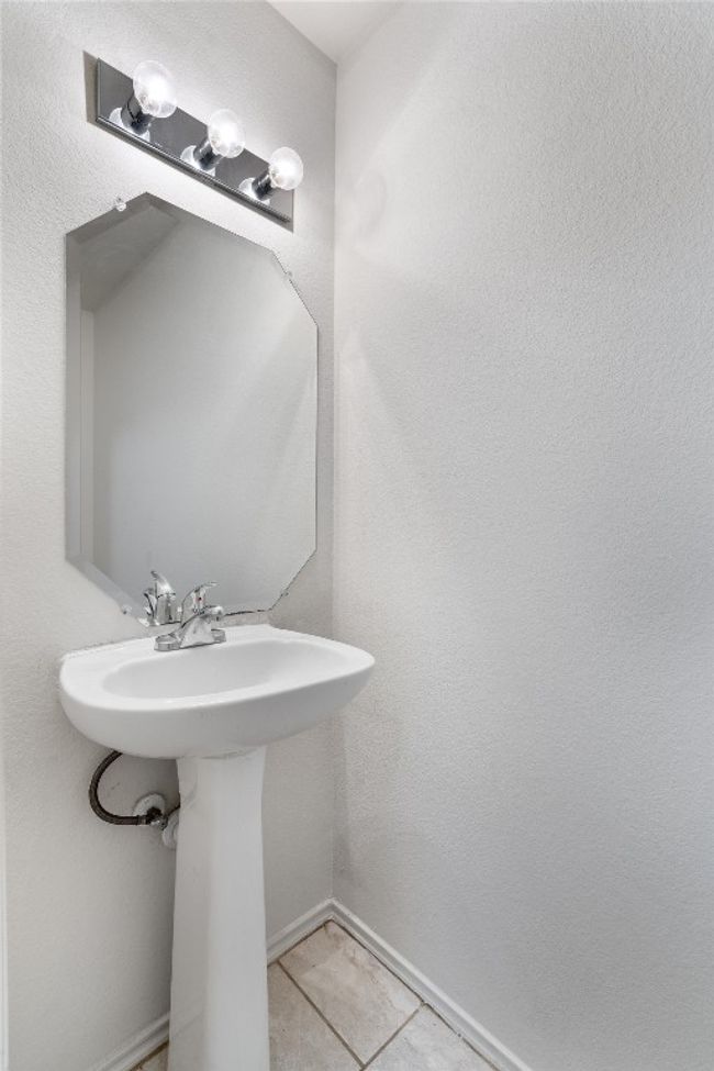 Bathroom featuring tile patterned flooring, a sink, and baseboards | Image 15