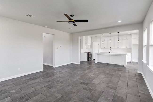 Unfurnished living room featuring a sink, ceiling fan, recessed lighting, and baseboards | Image 11