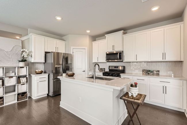 Kitchen featuring appliances with stainless steel finishes, light countertops, white cabinets, tasteful backsplash, and recessed lighting | Image 7