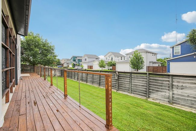 Wooden deck with a residential view and a fenced backyard | Image 40