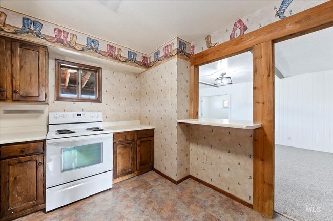 Kitchen with white range with electric stovetop and light countertops | Image 16