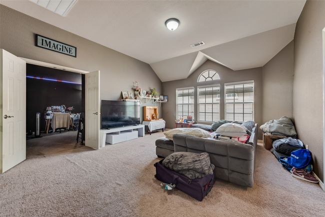 Carpeted living room featuring lofted ceiling | Image 22