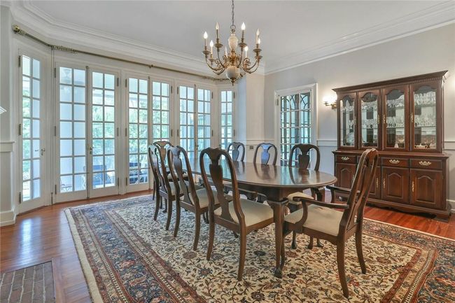 Drenched in sunlight, high ceilings, crown moldings and wall sconces set the mood | Image 9