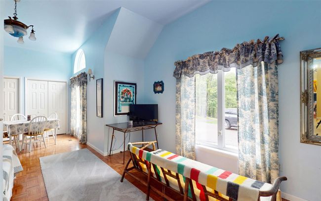 Living room featuring baseboards and high vaulted ceiling | Image 27