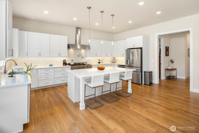 Another view of the kitchen, with the door to the guest suite and back hallway to the garage visible on the far right side of the photo. | Image 9