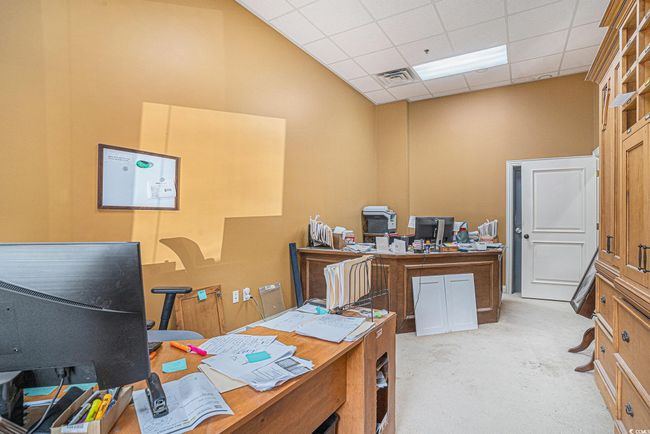 Home office with light carpet and a drop ceiling | Image 10