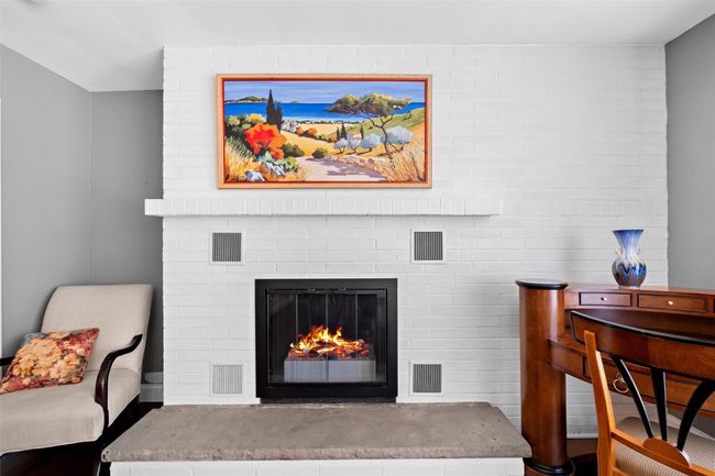 Living area featuring a fireplace and visible vents | Image 10